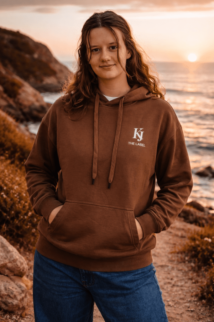 Girl standing in BROWN Whale Shark Hoodie - front, by the beach